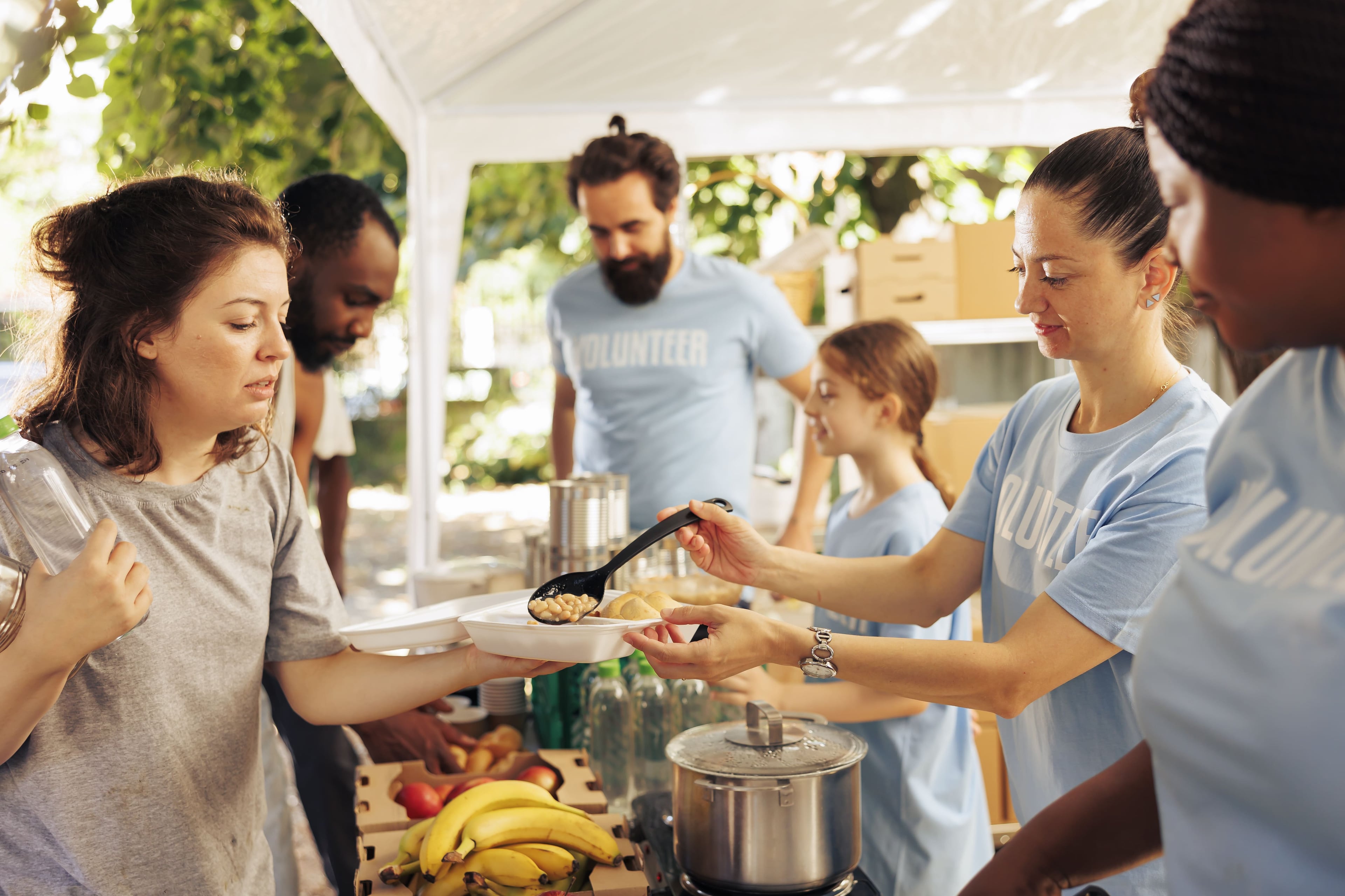 Charities — individuals volunteering at a food bank (hero)